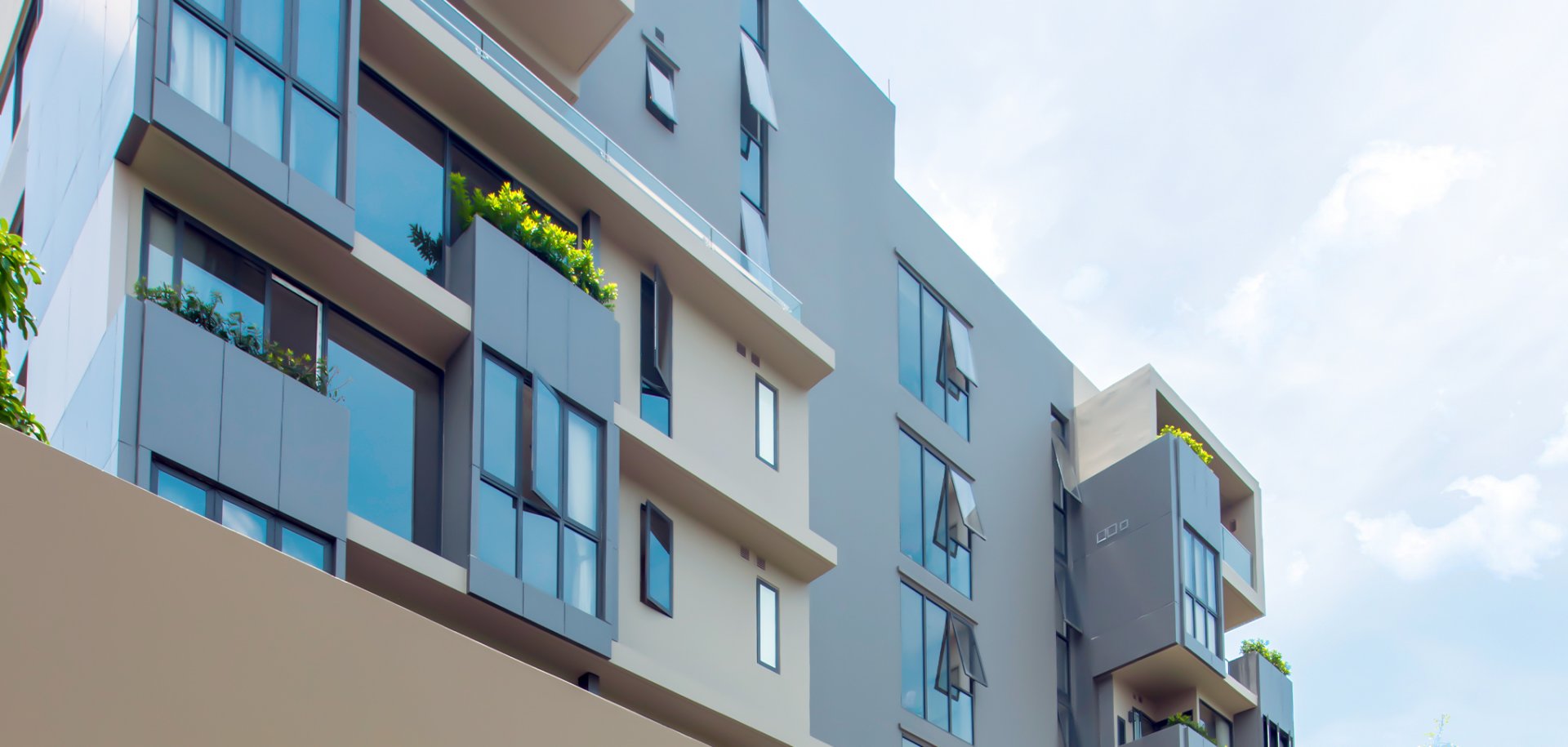 Bearing Residence low-rise facade with balconies seen from below