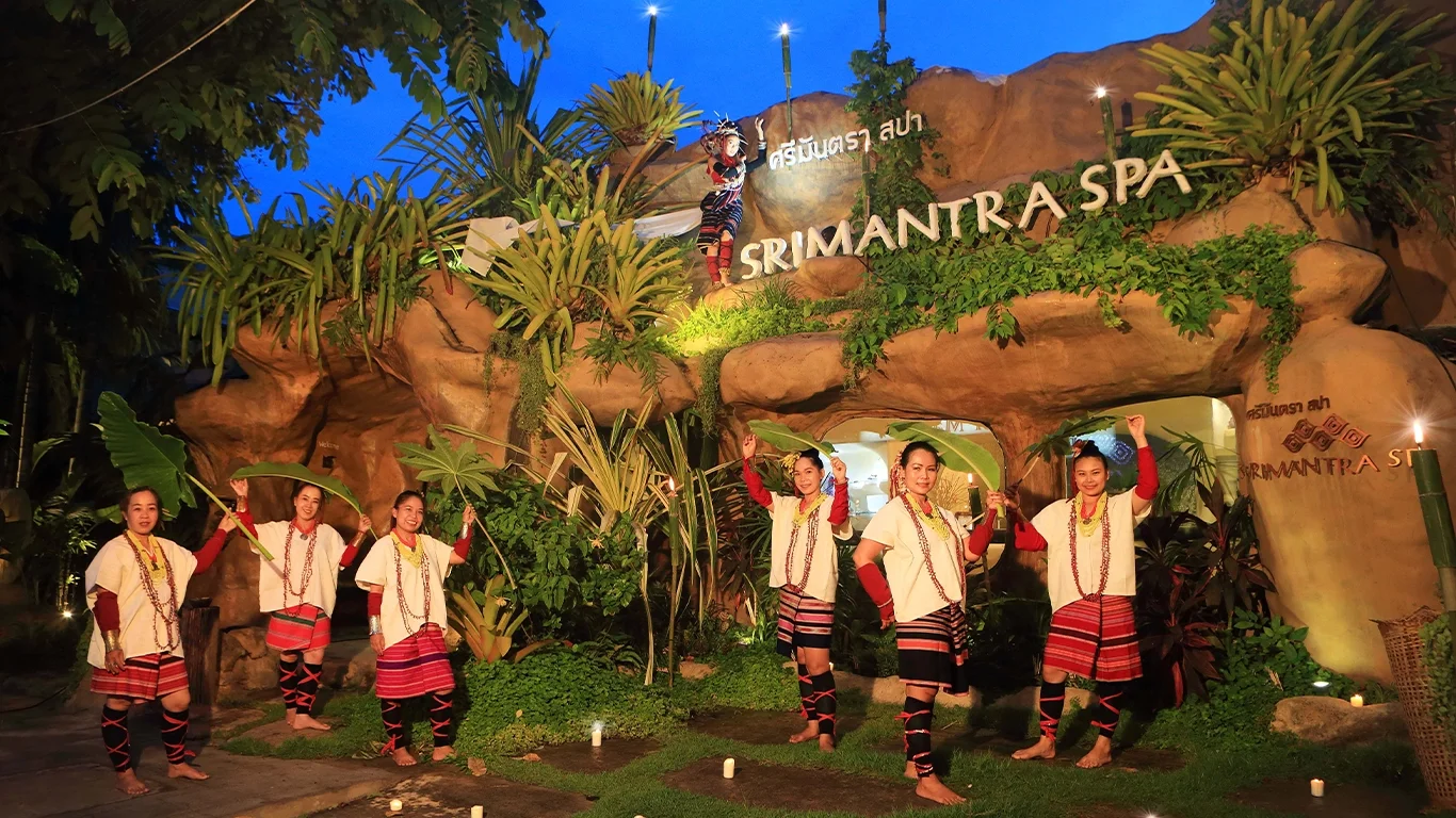 Srimantra Spa entrance decorated with natural rocks, tropical plants, and evening lights, creating a warm and relaxing atmosphere.