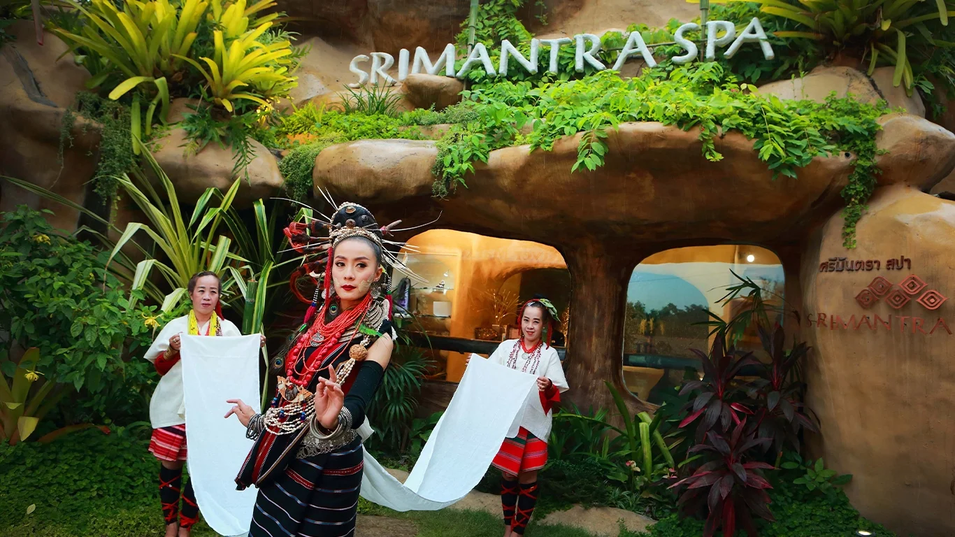 Performers in elaborate Lanna traditional costumes stand in front of Srimantra Spa in Chiang Mai, representing culture and hospitality.