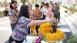 Management and employees of Thai Toshiba Lighting Co., Ltd. participated in a merit-making ceremony by offering alms to Buddhist monks and performing the traditional water-pouring ritual over a Buddha image in celebration of the Songkran Festival, seeking