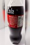 A bottle of Coca-Cola (Original taste Less sugar / A Thai label) 510 ml. which has My Slogan with My Signature