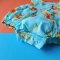 FLUTTER SLEEVE SUNFLOWER LIGHT BLUE ROMPER 100% PRINTED COTTON