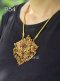 Handmade ancient Thai gold double-naga pendant (Uba style) featuring a central ruby surrounded by diamonds, accented with emeralds and traditional Repousse technique
