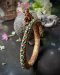 Elegant Naga Bracelet adorned with emeralds