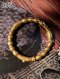 Antique Thai gold slip-on bangle with sugarcane motif and cabochon emerald, handcrafted by Thai Antique Thongboran