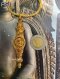 Antique gold Takrut amulet in a spindle shape, featuring hand-chased Naga serpent and Pracham Yam motifs